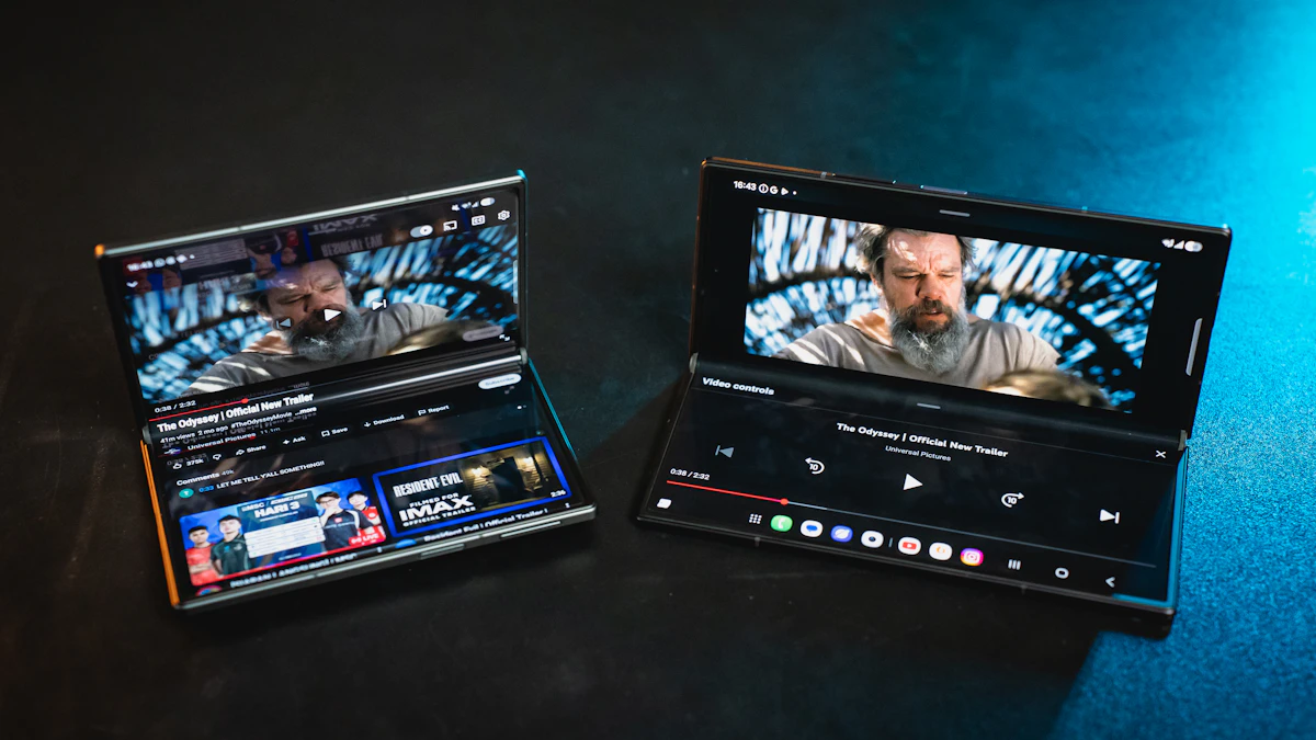 Two foldable smartphones opened flat on a dark background, each playing a video, showing their large inner screens