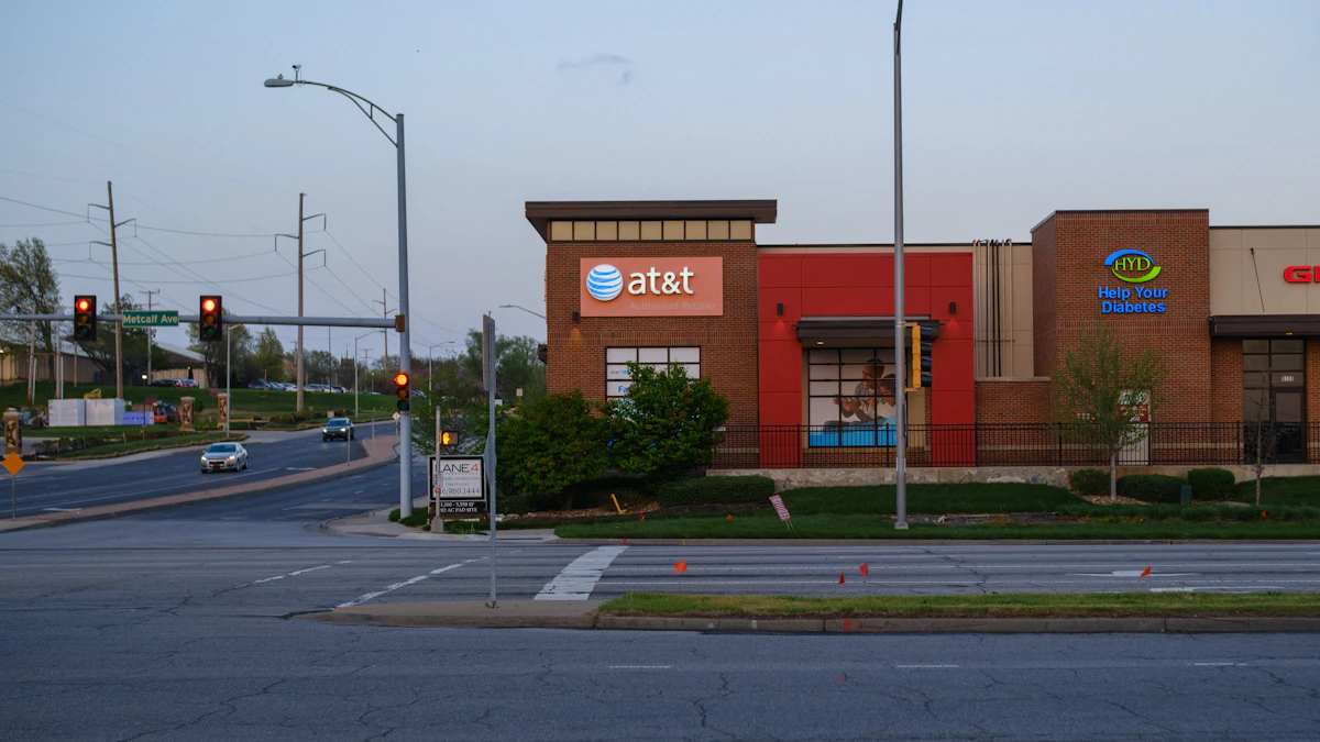 AT&T store sign glowing beside other shops on a city street at dusk, as breach settlement payouts near