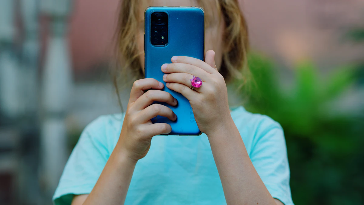 Young girl holding up a smartphone to take a picture, the kind of first phone parents compare for kids