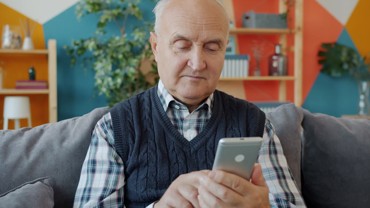 Older man relaxing on a couch while using a smartphone, the kind of everyday use a phone for seniors should make easy