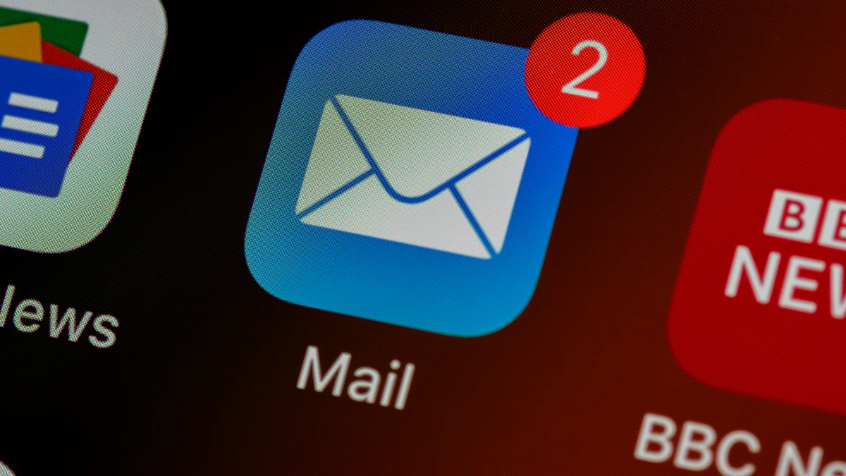 Close up of a mail app icon on a smartphone home screen, where scam emails and phishing messages often arrive