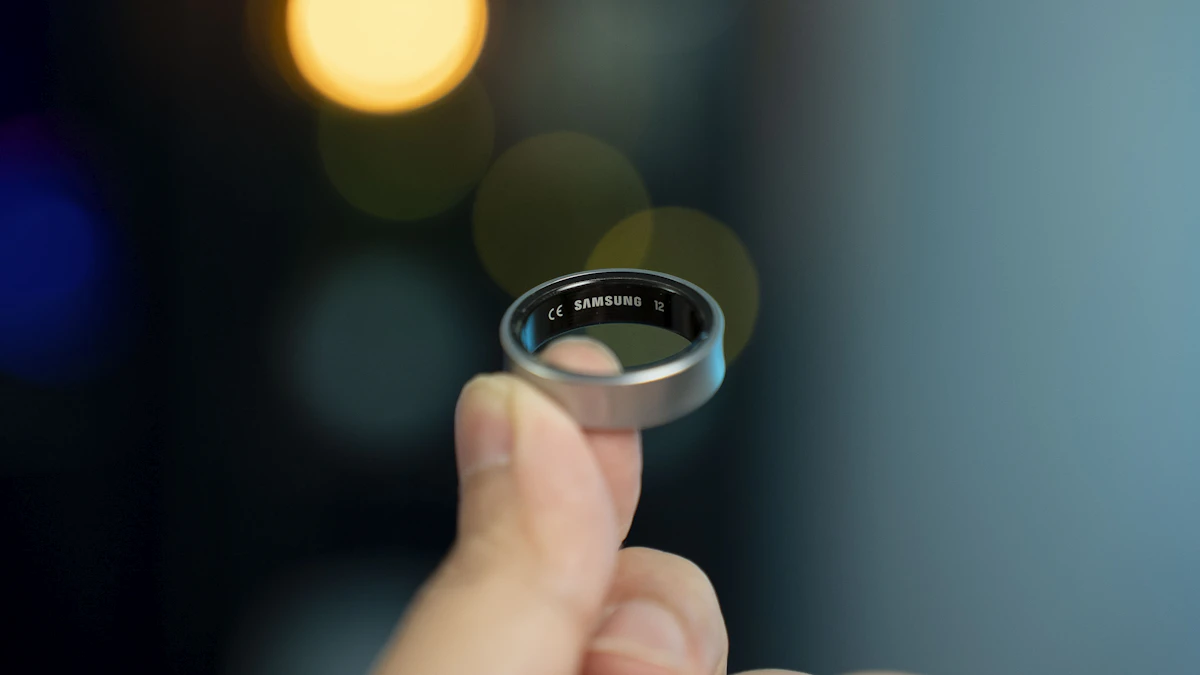 A hand holding a sleek smart ring, the kind of wearable at the center of the Oura and Ultrahuman patent fight