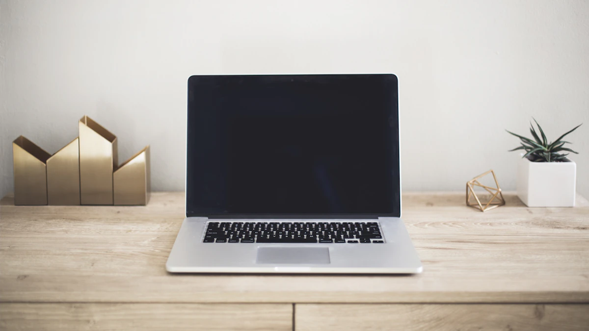 Silver MacBook Pro open on a wooden table, the laptop line Apple is expected to refresh with an OLED touchscreen